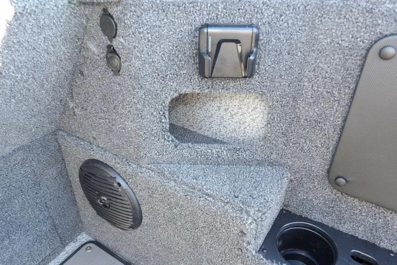 Slide: The Image of Interior detail of 2026 Lund 2075 Impact XS boat, featuring speaker and storage compartment. - 28