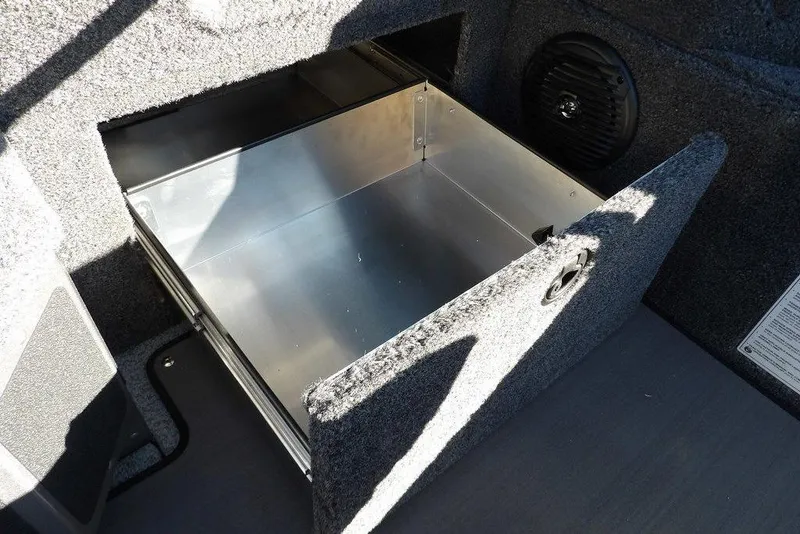 Slide: The Image of 2026 Lund 2075 Impact XS boat storage compartment with open metal drawer. - 29