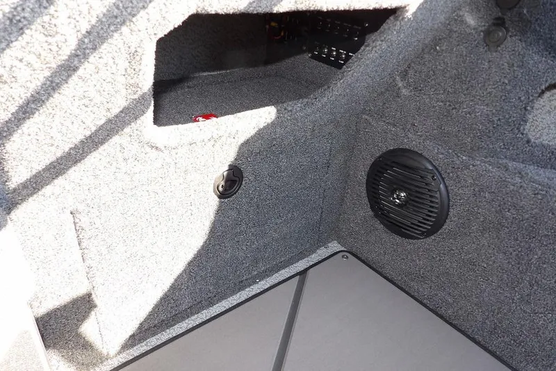 Slide: The Image of Interior view of 2026 Lund 2075 Impact XS boat, featuring speaker and storage compartment. - 30
