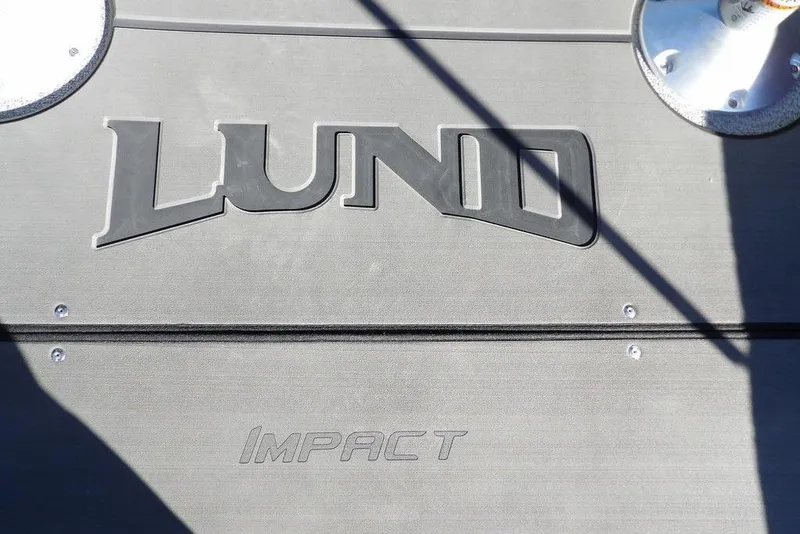 Slide: The Image of 2026 Lund 2075 Impact XS boat deck with logo and metal fixtures. - 32