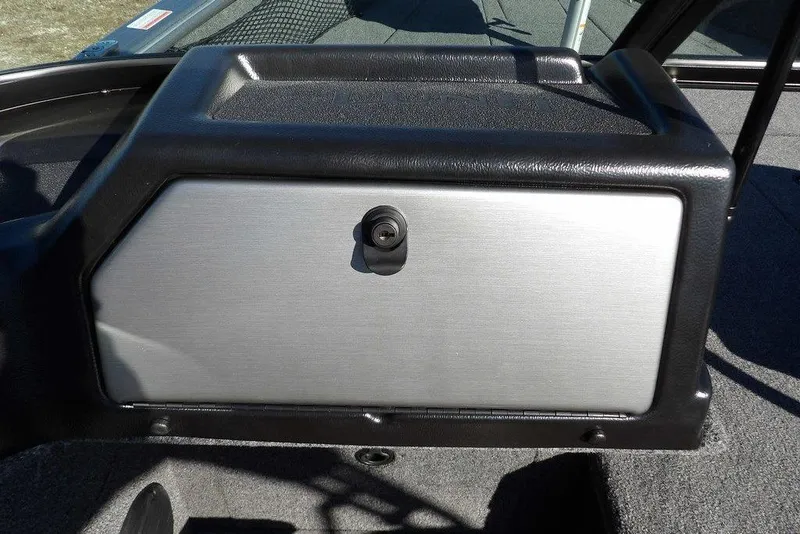 Slide: The Image of 2026 Lund 2075 Impact XS boat dashboard with secure storage compartment. - 34