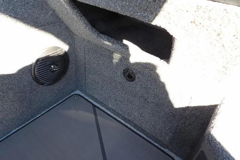 Slide: The Image of Interior view of 2026 Lund 2075 Impact XS boat, featuring speaker and storage compartment. - 38