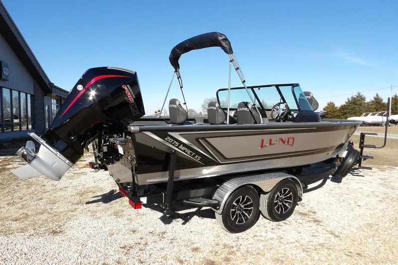 Slide: The Image of 2026 Lund 2075 Impact XS boat with powerful outboard motor on trailer. - 4