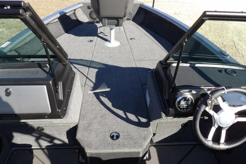 Slide: The Image of 2026 Lund 2075 Impact XS boat interior with steering wheel and open windshield. - 40