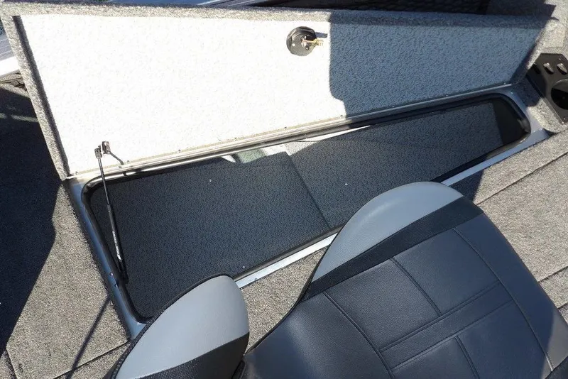 Slide: The Image of 2026 Lund 2075 Impact XS boat interior with open storage compartment and seat. - 43
