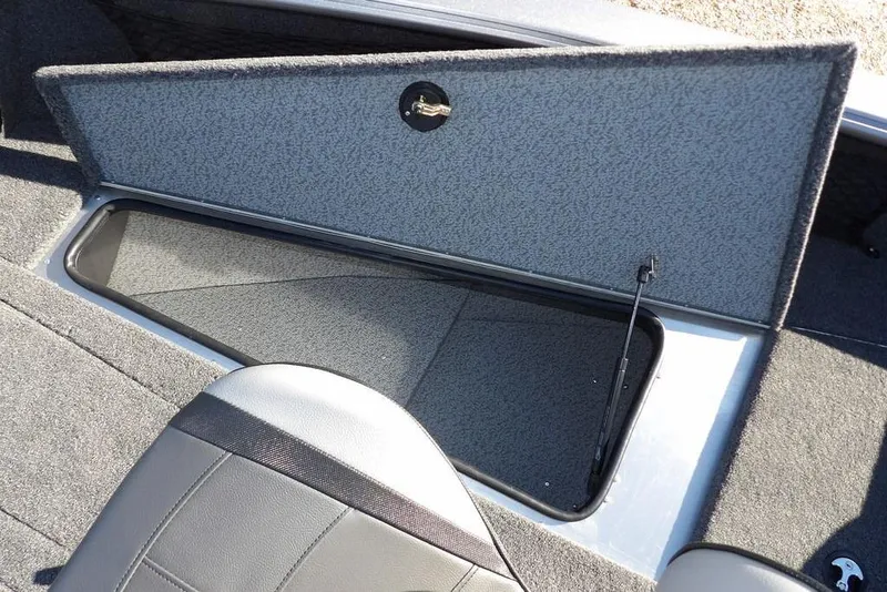 Slide: The Image of 2026 Lund 2075 Impact XS boat storage compartment with open lid and seat. - 45