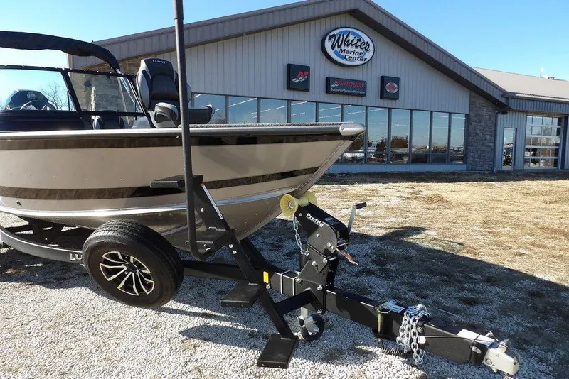 Slide: The Image of 2026 Lund 2075 Impact XS boat on trailer outside marine center. - 54