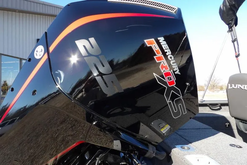 Slide: The Image of 2026 Lund 2075 Impact XS with Mercury Pro XS 225 engine, outdoor setting. - 55