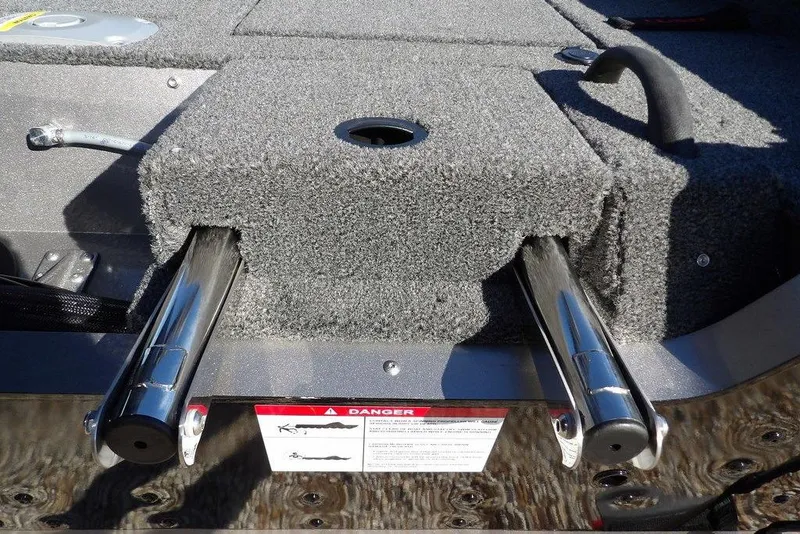 Slide: The Image of 2026 Lund 2075 Impact XS boat interior with carpeted deck and metal fittings. - 58