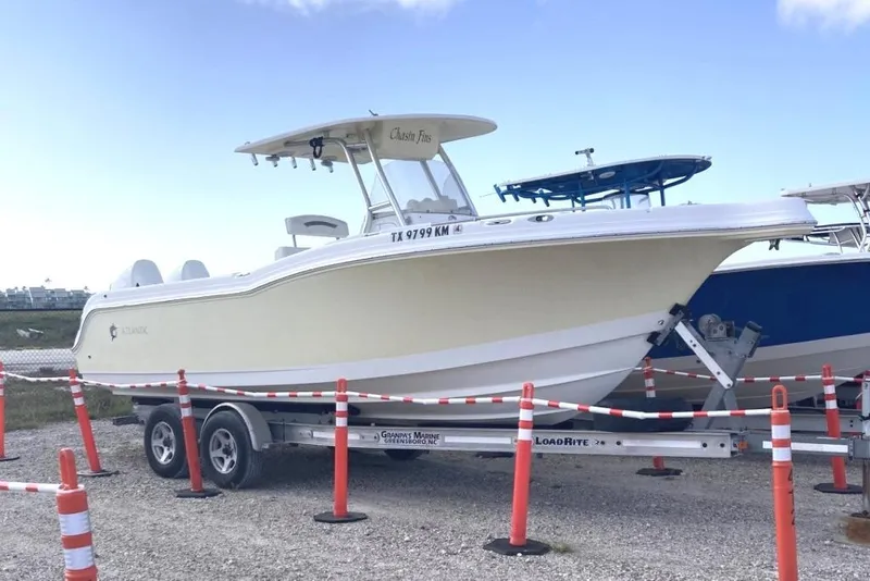 The Image of 2009 Atlantic 275 CC boat on trailer, parked outdoors with safety cones. - 0