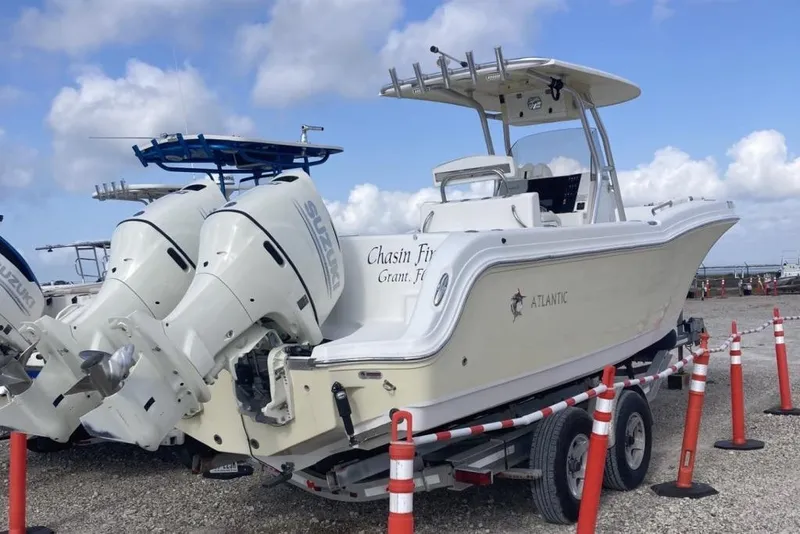 Slide: The Image of 2009 Atlantic 275 CC boat with twin Suzuki engines on a trailer. - 1