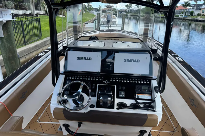 Slide: The Image of 2020 Fountain 38 Center Console boat interior with dual Simrad displays and steering wheel. - 14