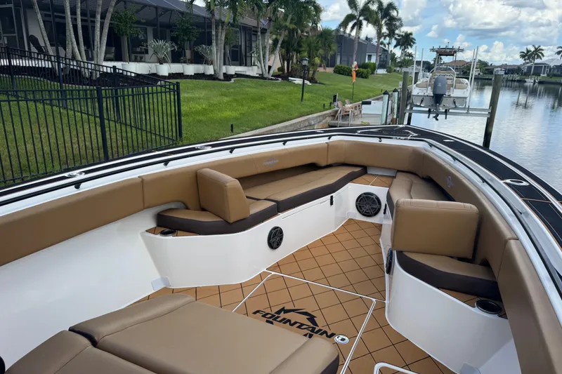 Slide: The Image of 2020 Fountain 38 Center Console boat with tan seating, docked by a canal. - 18
