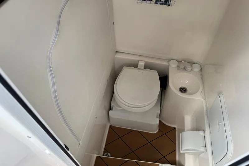 Slide: The Image of Compact bathroom in 2020 Fountain 38 Center Console boat with toilet and sink. - 21