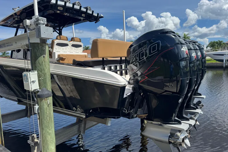 Slide: The Image of 2020 Fountain 38 Center Console boat with powerful outboard engines docked by the water. - 7