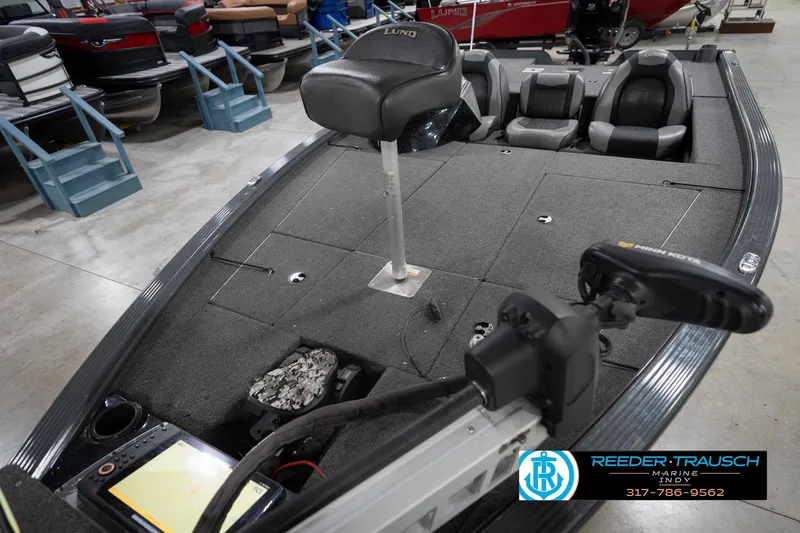 Slide: The Image of 2020 Lund 1875 Pro-V Bass boat interior with seating and fishing equipment. - 11