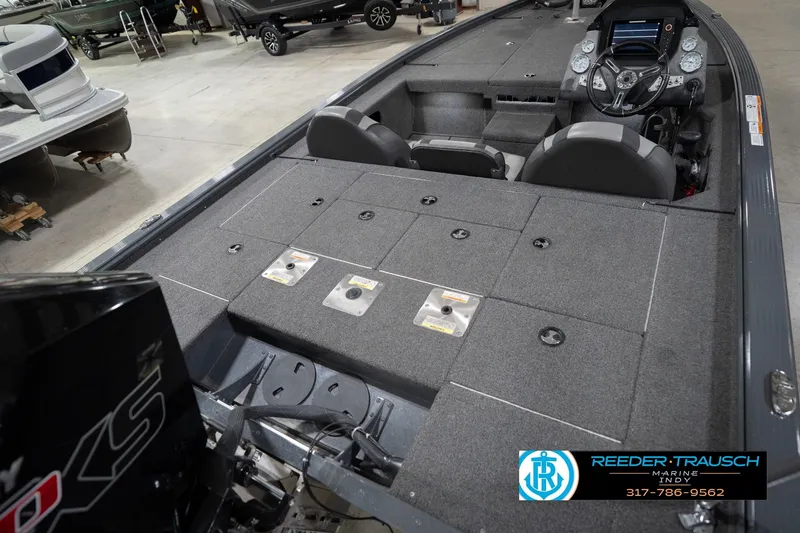 Slide: The Image of 2020 Lund 1875 Pro-V Bass boat interior with seating and control panel in showroom. - 13