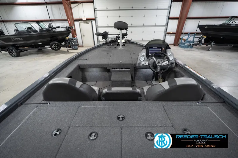 Slide: The Image of 2020 Lund 1875 Pro-V Bass boat interior with steering console in showroom. - 15