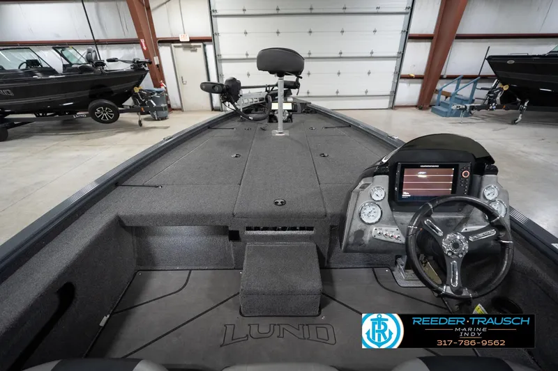 Slide: The Image of 2020 Lund 1875 Pro-V Bass boat interior with steering console and electronics in a showroom. - 16