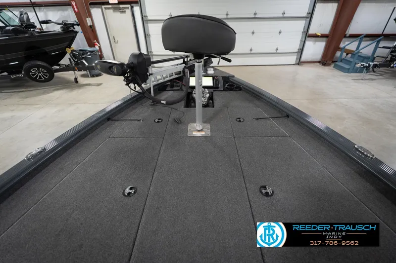 Slide: The Image of 2020 Lund 1875 Pro-V Bass boat interior with fishing seat and equipment in a showroom. - 17