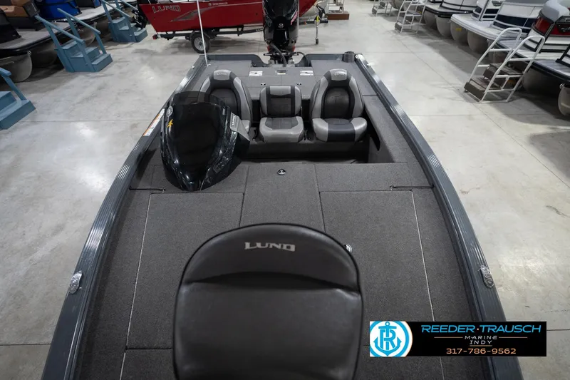Slide: The Image of 2020 Lund 1875 Pro-V Bass boat interior with seating and console, displayed in showroom. - 18