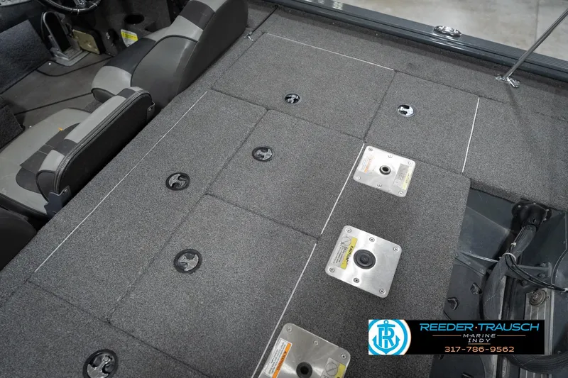 Slide: The Image of 2020 Lund 1875 Pro-V Bass boat interior with carpeted deck and seating. - 21