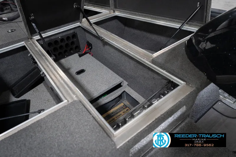 Slide: The Image of 2020 Lund 1875 Pro-V Bass boat storage compartments, open and organized, with visible branding. - 24
