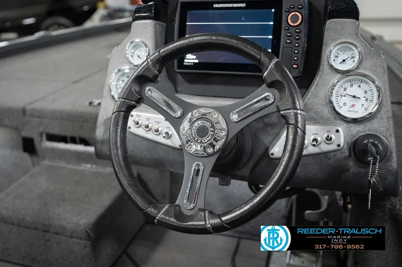 Slide: The Image of Steering wheel and dashboard of 2020 Lund 1875 Pro-V Bass boat with gauges and controls. - 27
