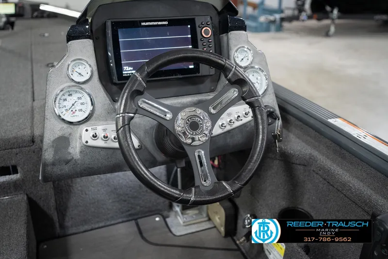 Slide: The Image of 2020 Lund 1875 Pro-V Bass boat dashboard with steering wheel and Humminbird display. - 28