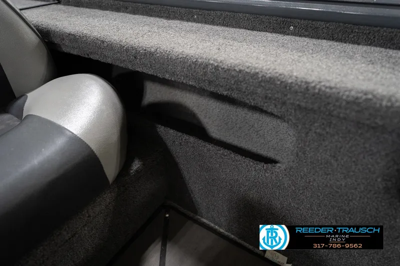 Slide: The Image of 2020 Lund 1875 Pro-V Bass boat interior with gray seating and carpeted storage. - 41