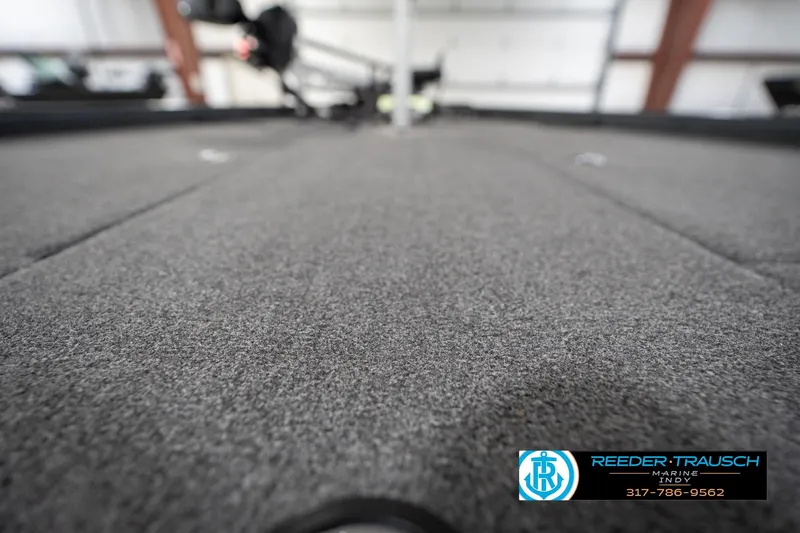 Slide: The Image of 2020 Lund 1875 Pro-V Bass boat interior with carpeted deck, Reeder-Trausch Marine logo. - 43