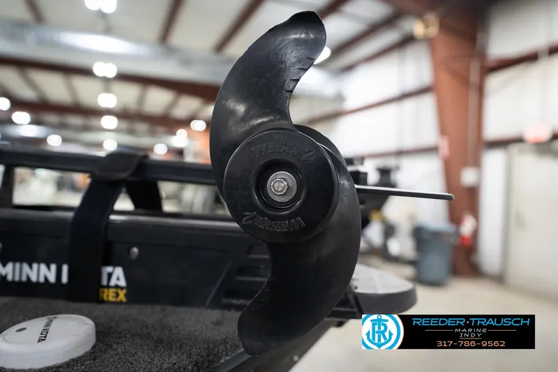 Slide: The Image of 2020 Lund 1875 Pro-V Bass boat propeller in a showroom, featuring Minn Kota branding. - 51