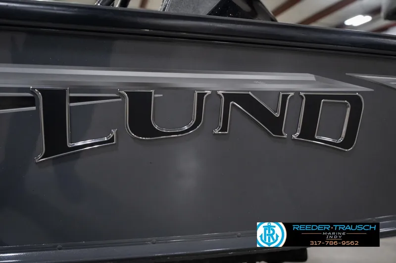 Slide: The Image of 2020 Lund 1875 Pro-V Bass boat logo close-up with dealership branding. - 52