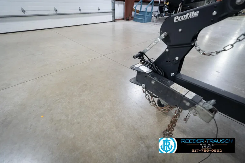 Slide: The Image of Trailer hitch of a 2020 Lund 1875 Pro-V Bass boat in a garage setting. - 56