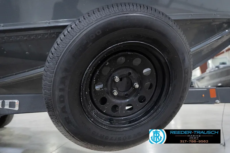 Slide: The Image of 2020 Lund 1875 Pro-V Bass trailer wheel, black rim, displayed at Reeder Trausch Marine. - 58