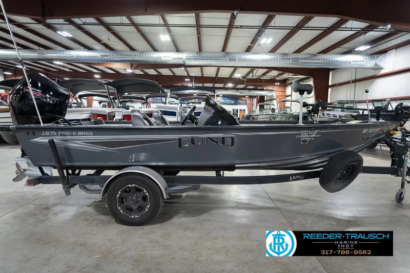 Slide: The Image of 2020 Lund 1875 Pro-V Bass boat in showroom, side view, on trailer. - 6