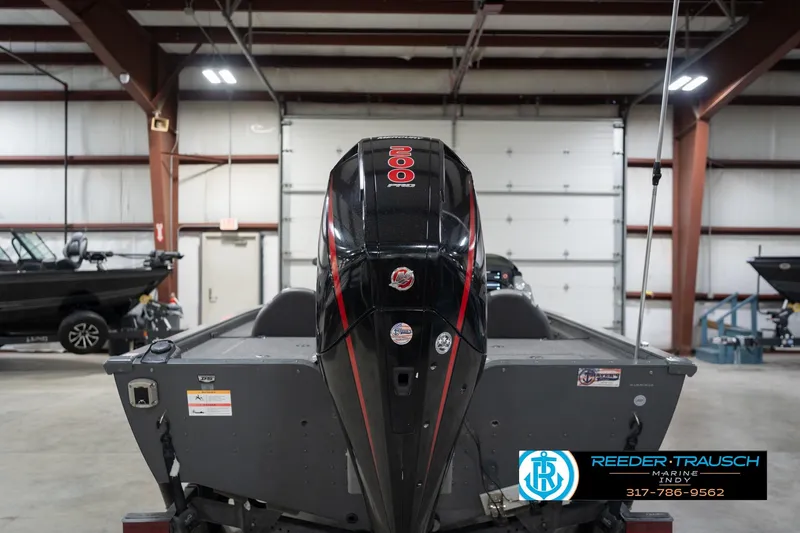 Slide: The Image of 2020 Lund 1875 Pro-V Bass boat in indoor showroom, rear view with motor. - 8