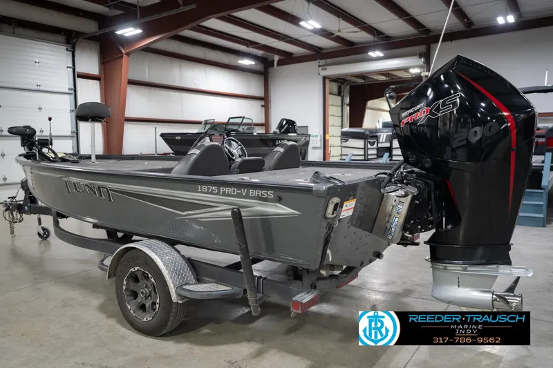 Slide: The Image of 2020 Lund 1875 Pro-V Bass boat with Mercury Pro XS engine in a showroom. - 9