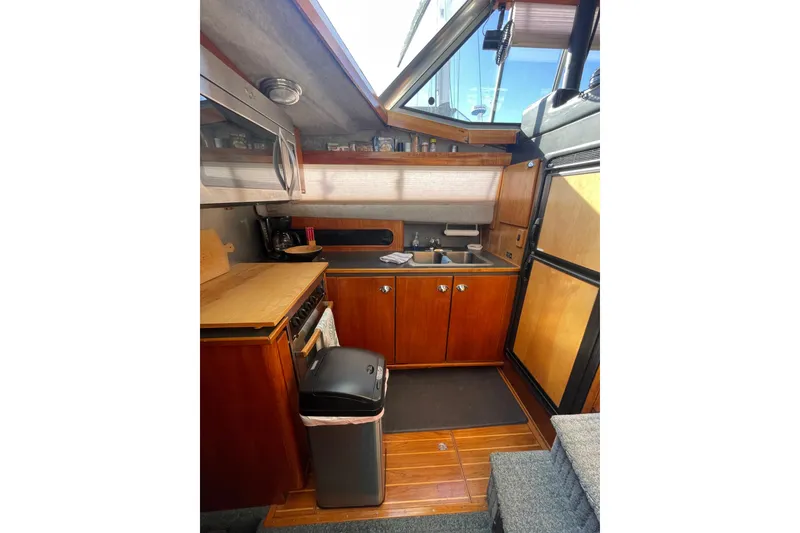 Slide: The Image of 1988 Bayliner 3888 Motoryacht kitchen with wooden cabinets, sink, and appliances. - 11
