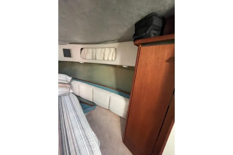 Slide: The Image of Interior cabin of 1988 Bayliner 3888 Motoryacht with wood paneling and cushioned seating. - 16