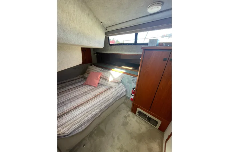 Slide: The Image of Cozy cabin interior of 1988 Bayliner 3888 Motoryacht with bed and wooden storage. - 17