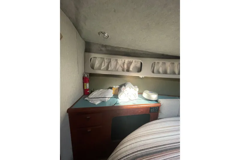 Slide: The Image of 1988 Bayliner 3888 Motoryacht interior cabin with storage and fire extinguisher. - 18