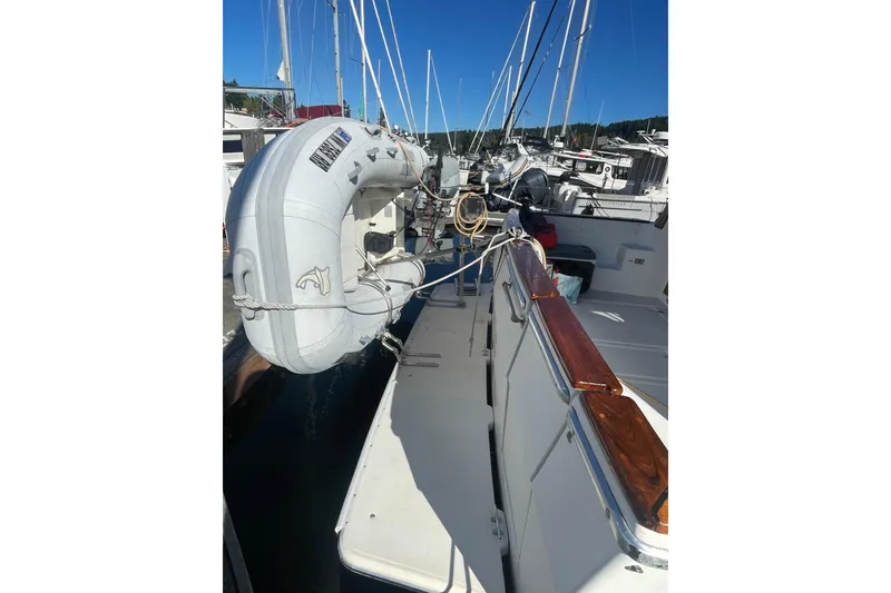 Slide: The Image of 1988 Bayliner 3888 Motoryacht docked with inflatable dinghy attached. - 2