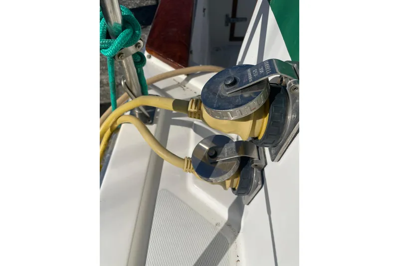 Slide: The Image of Power connections on a 1988 Bayliner 3888 Motoryacht, featuring yellow cables and metal fittings. - 28