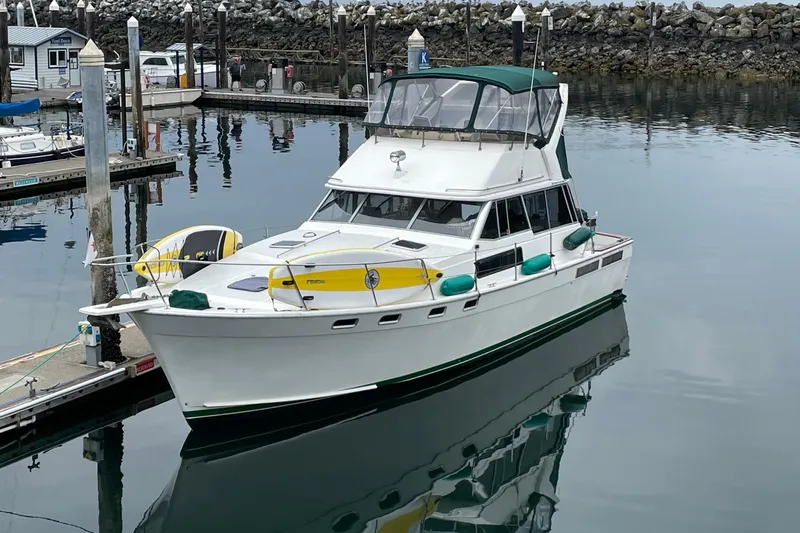Slide: The Image of 1988 Bayliner 3888 Motoryacht docked in a serene marina setting. - 33
