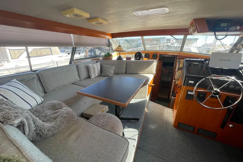 Slide: The Image of 1989 Bayliner 3888 Motoryacht interior with cozy seating and helm station. - 7