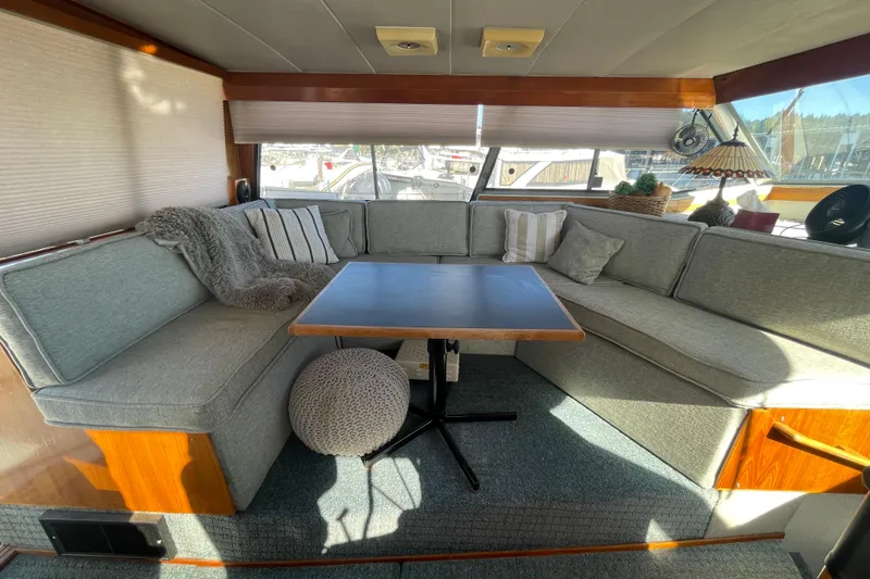 Slide: The Image of 1989 Bayliner 3888 Motoryacht interior with cozy seating and table setup. - 8