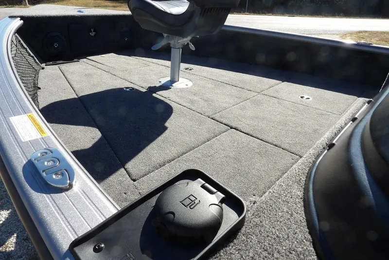 Slide: The Image of 2026 Lund 2075 Impact XS boat interior with carpeted deck and seating. - 16