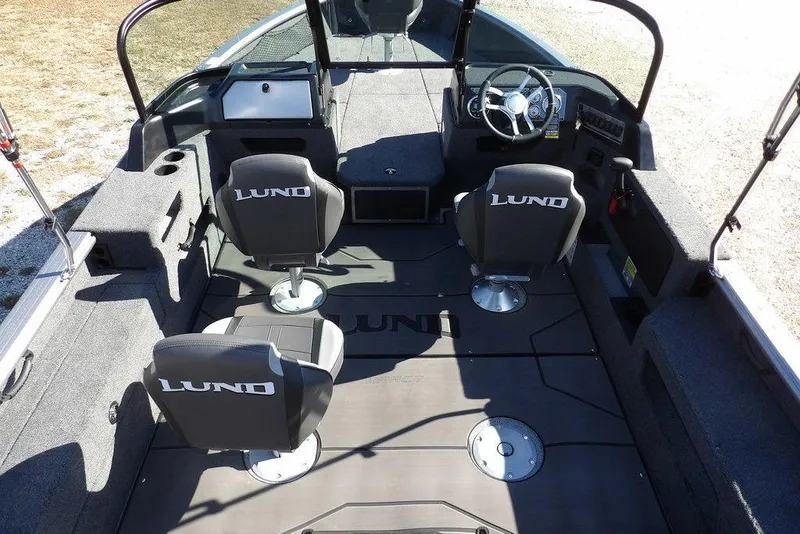 Slide: The Image of 2026 Lund 2075 Impact XS boat interior with seating and steering console. - 20