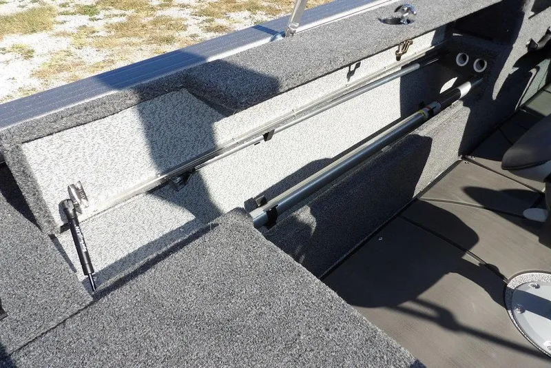Slide: The Image of 2026 Lund 2075 Impact XS boat interior with rod storage compartment. - 21